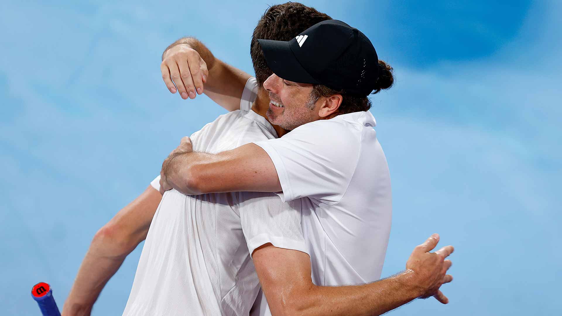 Hubert Hurkacz and Nicolas Massu embrace after Hurkacz's win against Alexander Zverev earlier in the United Cup.
