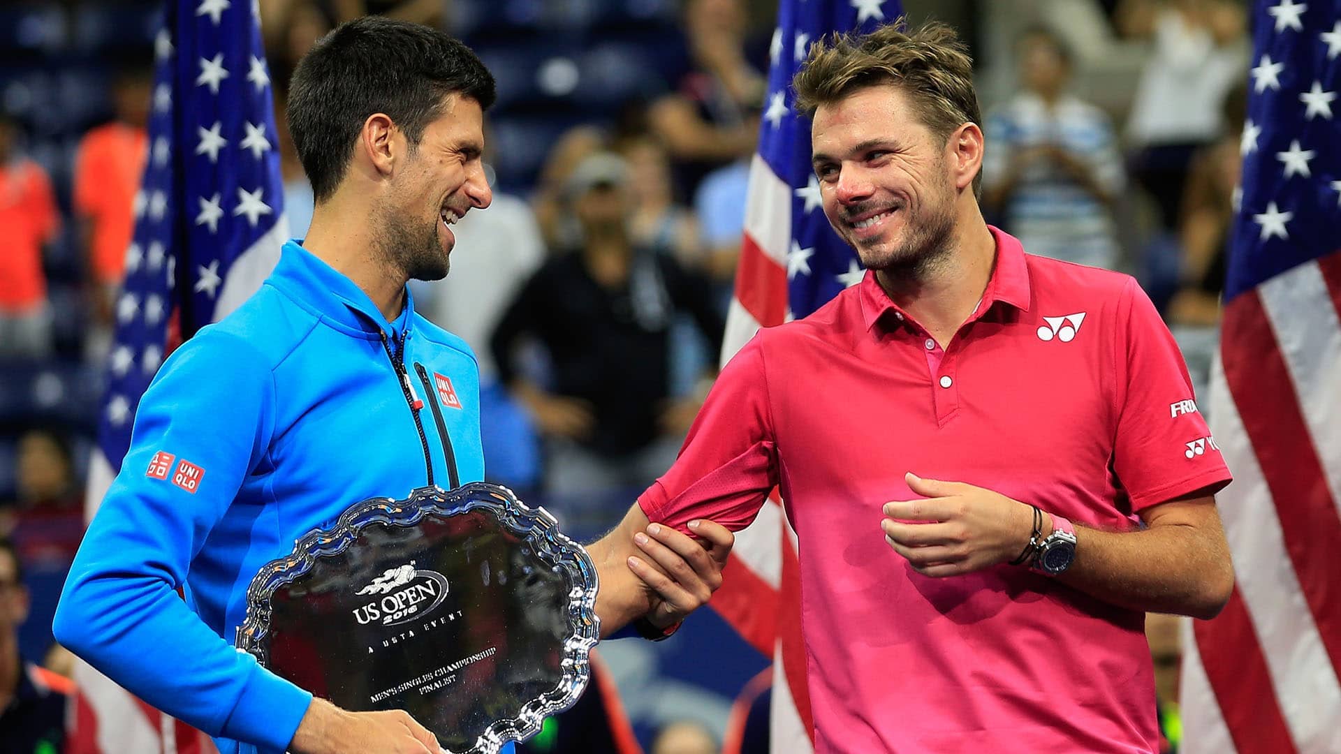 Novak Djokovic shares a laugh with Stan Wawrinka at the 2016 US Open trophy ceremony.